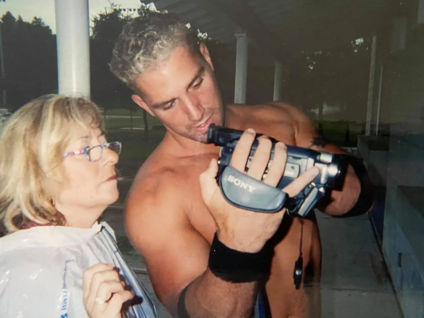 A young Regan Weiss behind a video camera