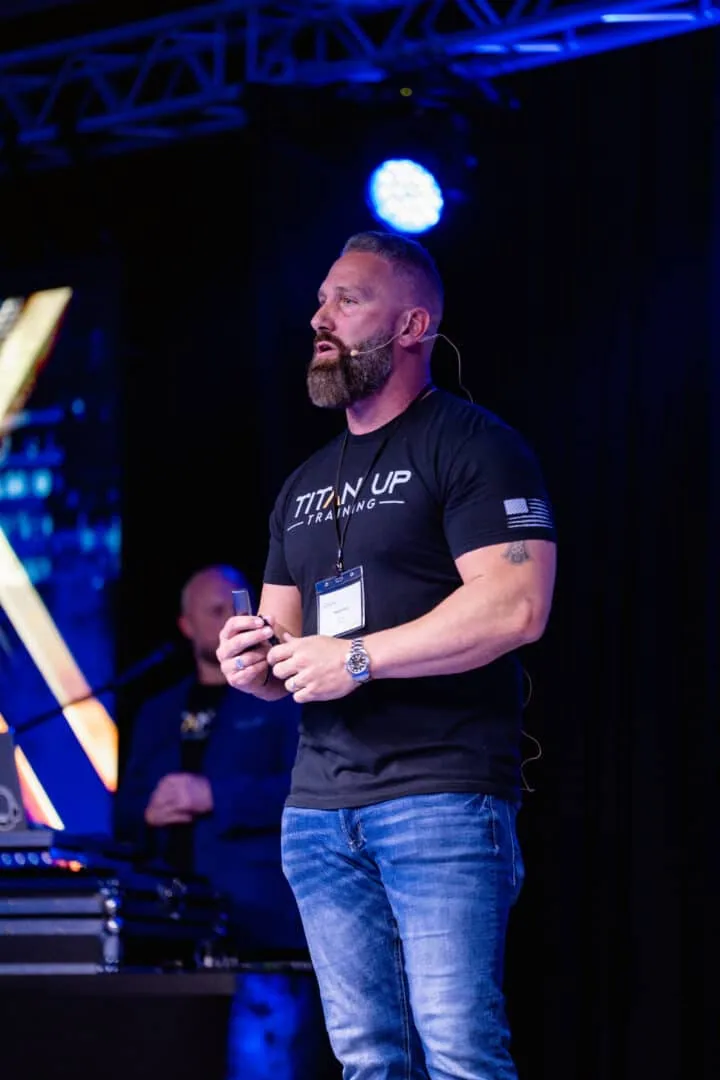 Regan Weiss speaking on stage at the Titan Up Retreat 2024